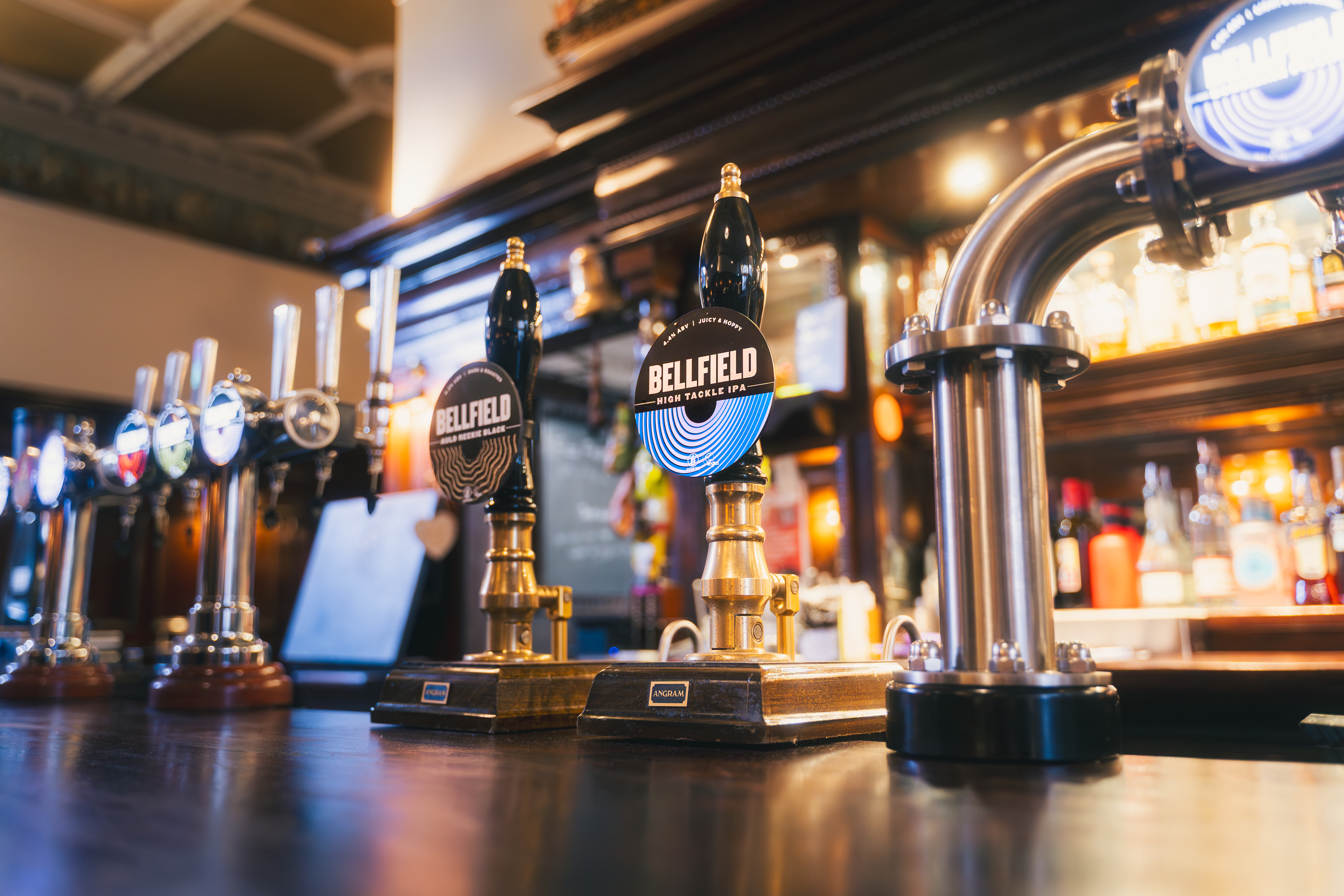 A row of Bellfield beer taps along the bar at Nobles, Edinburgh